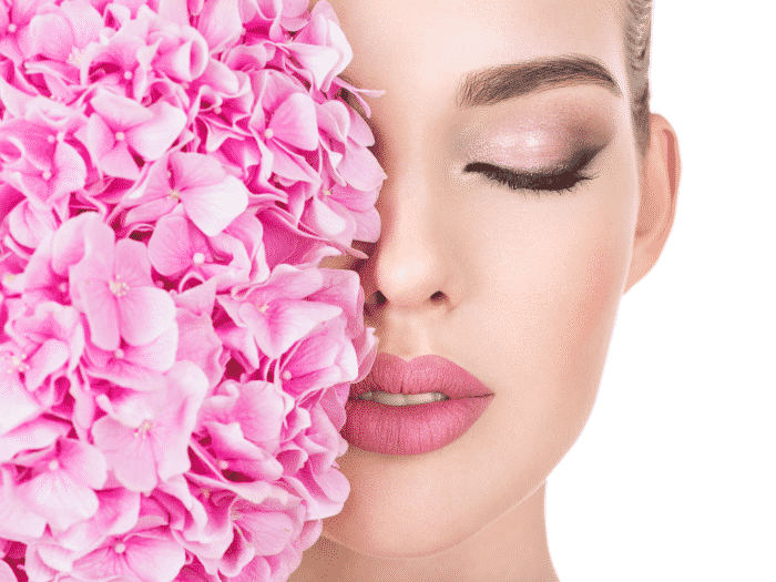 young-beautiful-woman-with-flowers-near-face 700x